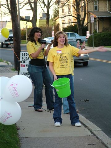 Girls wave on happy customers